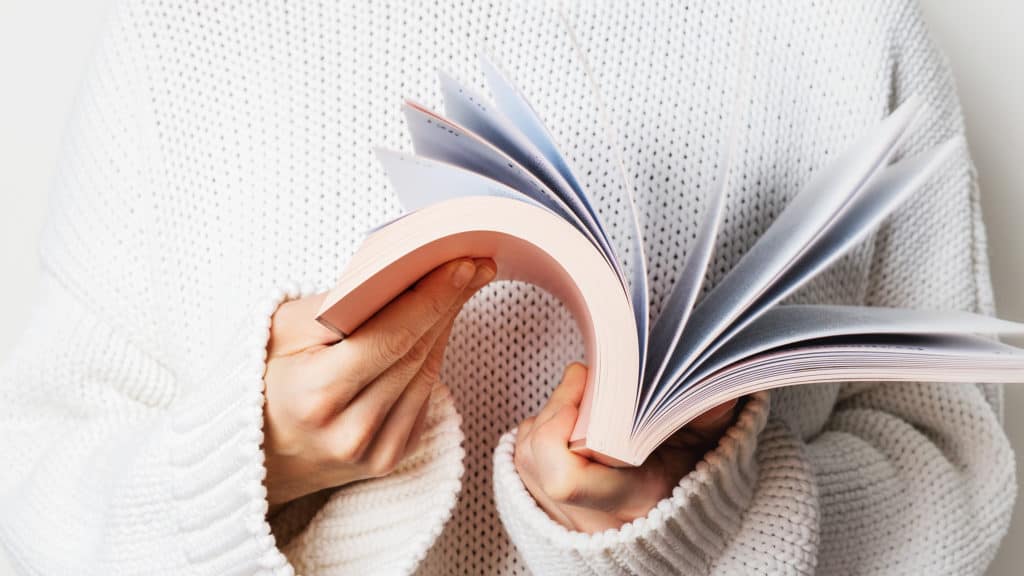 Woman closeup flipping through book