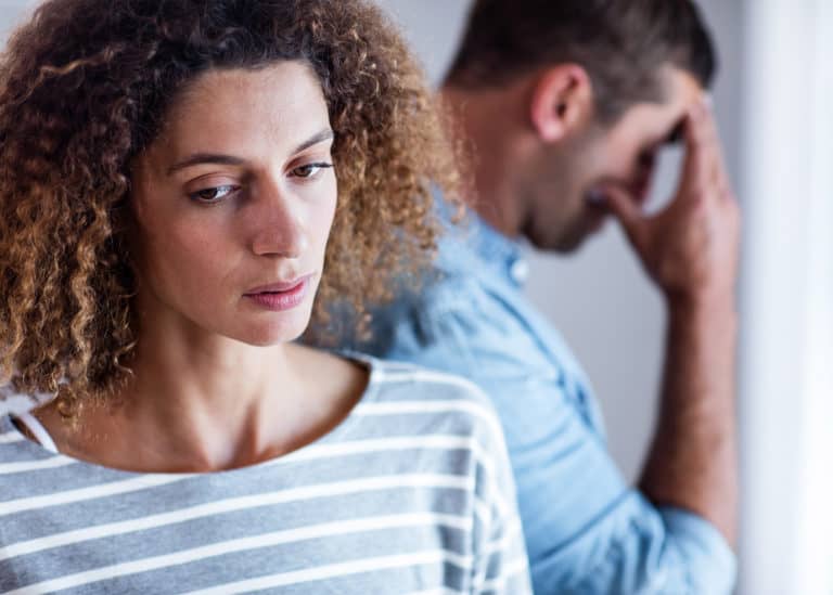 unhappy-woman-with-man-in-the-background