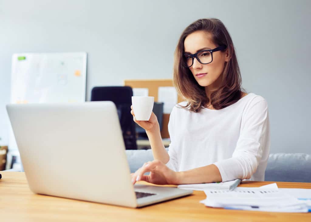 Busy-business-woman-using-laptop-in-home-office