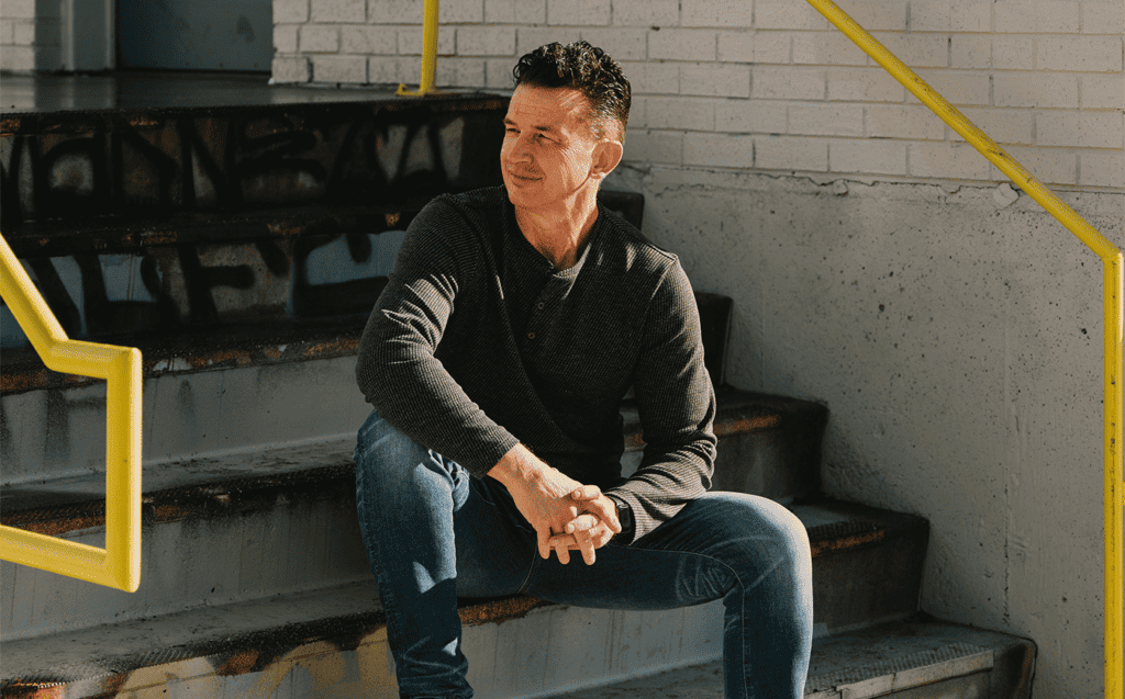 Greg Stier sitting on an outdoor staircase