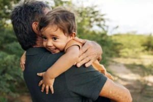 Happy grandson being held by his grandfather