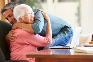 Mother hugging adult son.